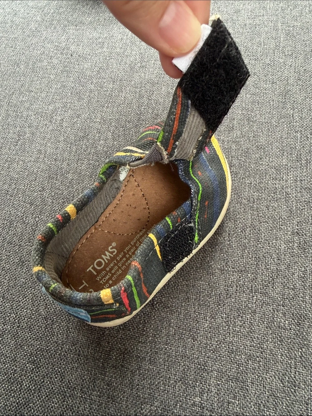 TOMS Baby Slip-On Shoes in Black with Multicolor Stripes